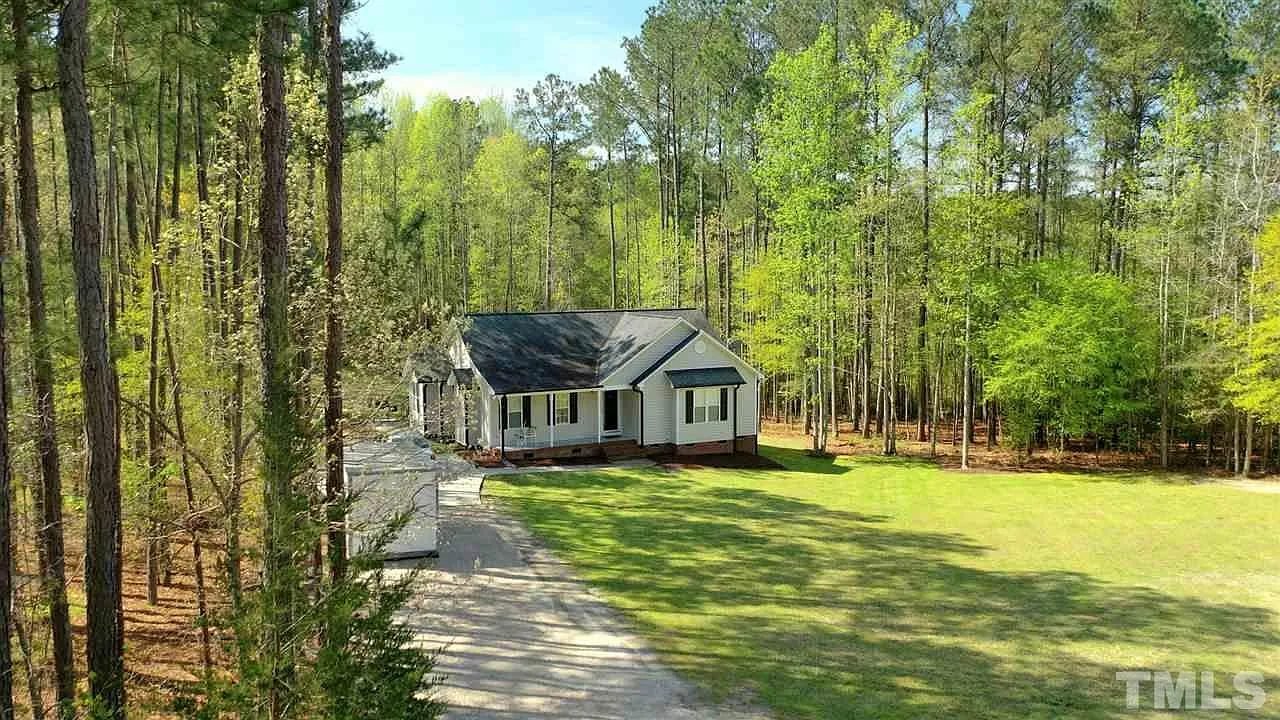 Aerial view of a home surrounded by tall pine trees in Raleigh, NC